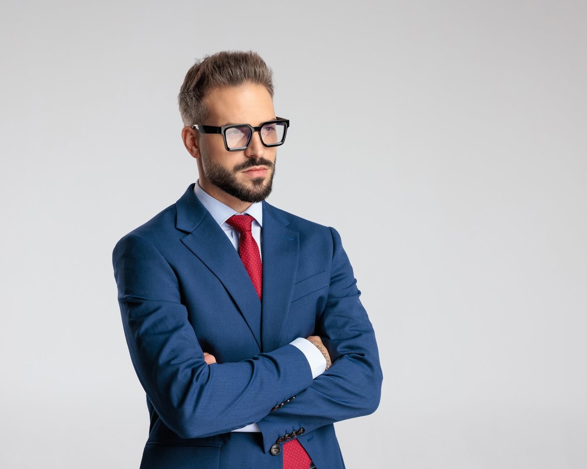 Experienced international language coach with glasses in a navy suit